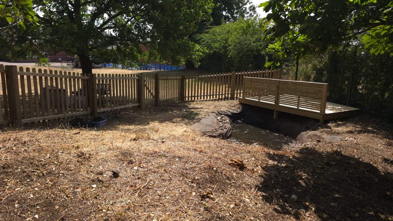 New picket fencing running around the pond beside the new decking