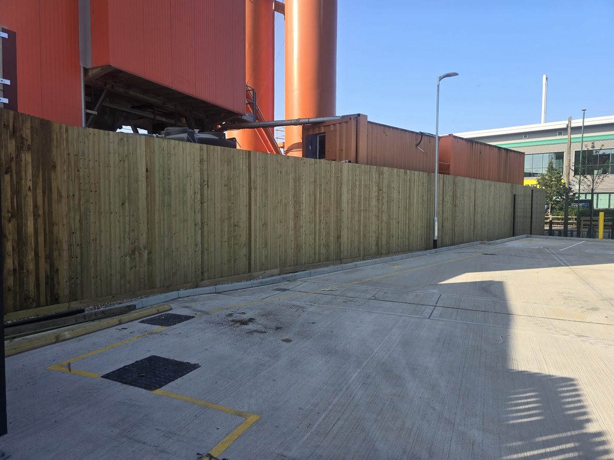 Site perimeter hoarding around a commercial unit